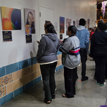 Artists and their families look at the pieces on display as part of the Youth Art Contest + Exhibit at the New Orleans Healing Center