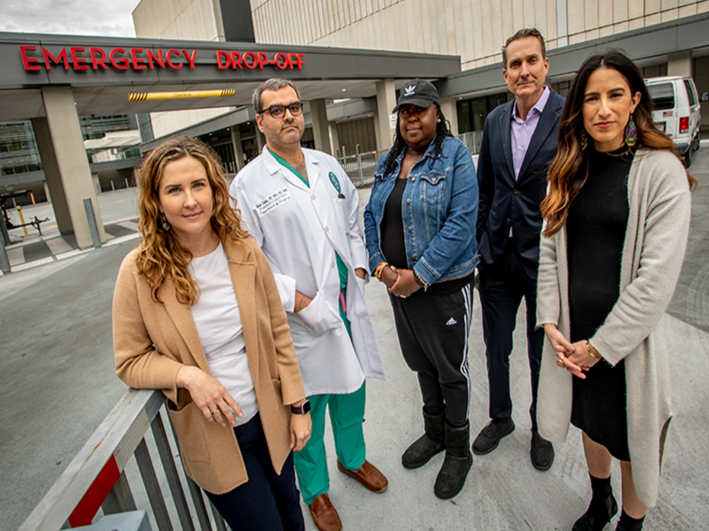 SHIFT staff stand outside of a hospital emergency room.